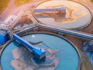 Aerial view of industrial water treatment facility with sedimentation tanks pulp in copper and gold mining at sunset © Parilov