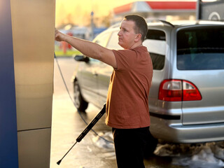 Man refueling car at gas station