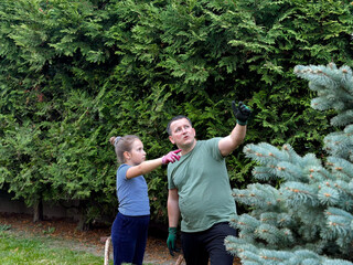 Father and daughter gardening together