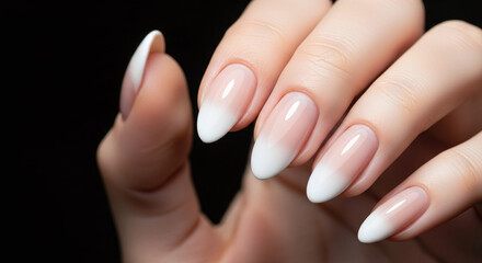 Elegant ombre manicure on female hand with almond shaped nails and glossy finish studio shot