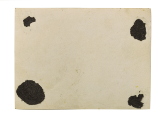 A blank, old-fashioned card with distinctive black smudges in the corners, evoking a sense of nostalgia and forgotten memories.