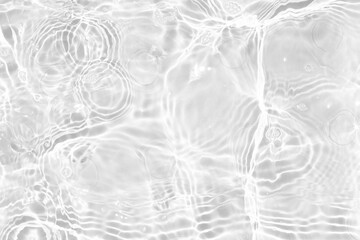 White water with ripples on the surface. Defocus blurred transparent white colored clear calm water surface texture with splashes and bubbles. Water waves with shining pattern texture background.