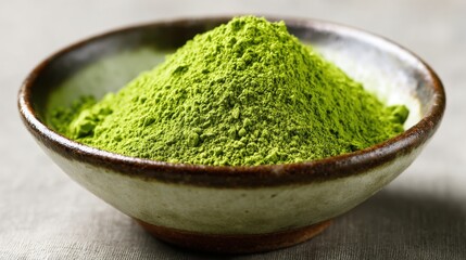 Green matcha powder sits in a bowl waiting to be whisked into a fragrant tea blend.