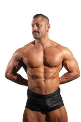 Fototapeta premium Latin bodybuilder showing muscular back and chest while posing with hands behind his back in studio against white background. Real photograph showing strength and masculine fitness aesthetics.