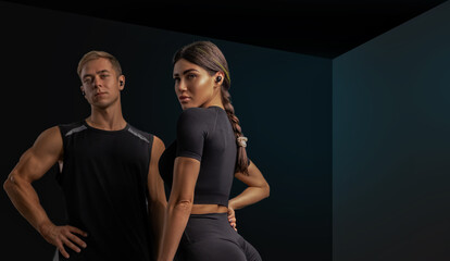 A man and a woman stand together in a sleek gym both dressed in athletic gear. They exude confidence and motivation ready to tackle their workout goals.