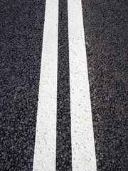 Fototapeta premium freshly painted double solid lines on new asphalt