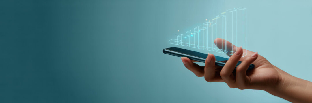 Hand holding smartphone with holographic expanding building models rising from the screen, visualizing smart city growth, real estate investment, urban development and digital infrastructure