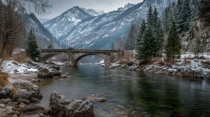 Majestic stone bridge spans serene river amidst snowy winter mountains and dense pine forests, evoking tranquility and adventure