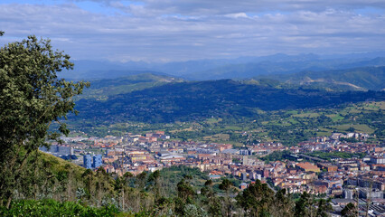 High-angle panoramic view of the city of Oviedo, Asturias, Spain, nestled in a wide green valley
