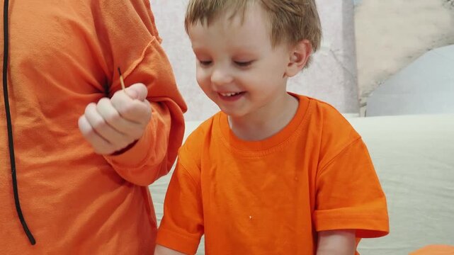 A family with young children celebrates Thanksgiving at home with roast turkey and traditional dishes. The table is set. The concept is one of celebration, tradition, love, care, and respect. They loo