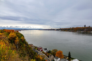 View of St Lawrence River from Terrasse du Chevalier-de-Levis in autumn, showcasing vibrant foliage and serene waters.