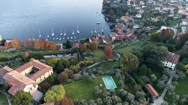 Aerial drone view of villas and marina in Menaggio

Drone shot over Menaggio&rsquo;s lakeside villas, gardens, and anchored sailboats along the calm blue waters of Lake Como.

