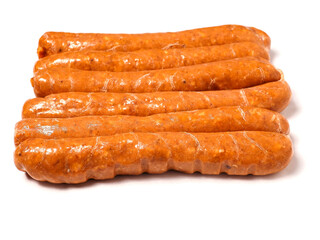 A row of top quality hot dogs are sitting on a white background. The hot dogs are covered in a brown glaze and are arranged in a neat row. Simple product made to highest standard.