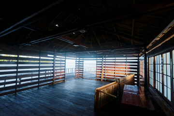 Interior of a Wooden Lakeside Pavilion with Scenic Views