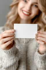 Woman Showcasing a Blank Card With Elegantly Manicured Nails in a Softly Blurred Background Setting