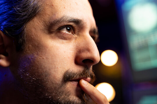 Close up of hacker focused on getting undetectable virus past antivirus protection. Cybercriminal in secret hideout concentrating on developing data mining script to breach firewalls