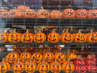 Halloween pumpkin decorations on store shelf with smiling jack o lantern faces