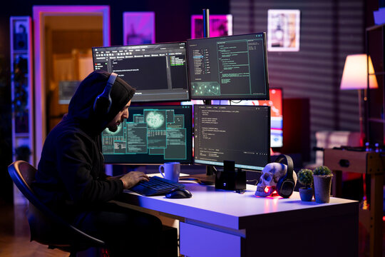 Hacker listening music while using ransomware attacks to hold company systems hostage and demand payments. Rogue engineer wearing headphones hacking enterprise networks, encrypting files