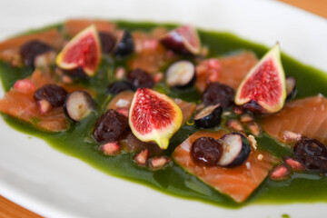 Gourmet Salmon Carpaccio with Fresh Figs, Berries, and Green Herb Sauce