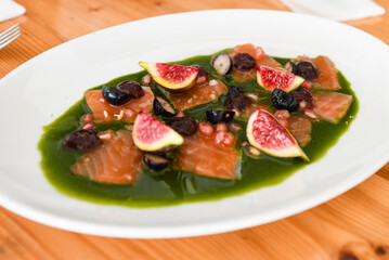 Gourmet Salmon Carpaccio with Fresh Figs, Berries, and Green Herb Sauce