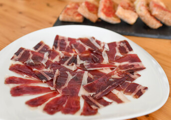 Delicious Sliced Cured Ham on a White Plate