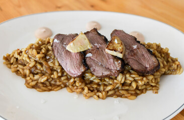 Risotto with roast beef and parmesan cheese on a plate