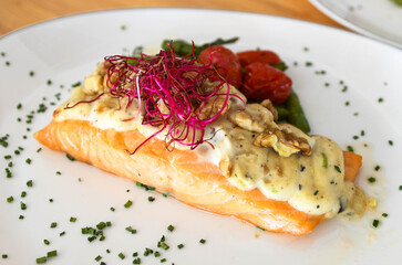 Salmon steak with mushroom sauce in white plate 