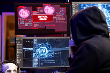 Hacker seeing critical error warning on computer when hacking firewalls using machine learning. Evil man failing to break into enterprise database because of malfunctioning virus software