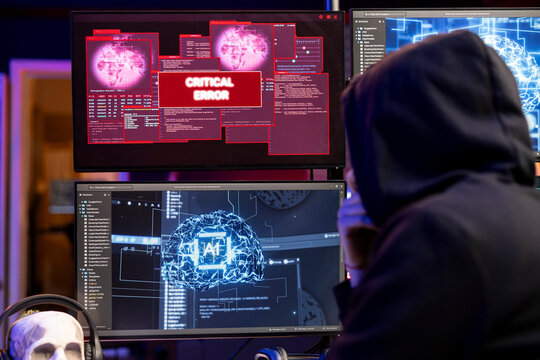 Hacker seeing critical error warning on computer when hacking firewalls using machine learning. Evil man failing to break into enterprise database because of malfunctioning virus software
