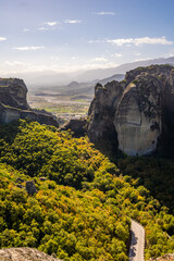 High-Angle Vertical View of the Meteora Sandstone Pillars, Overlooking a Winding Road through the Lush Green Valley and Stretching Landscape of Thessaly, Greece
