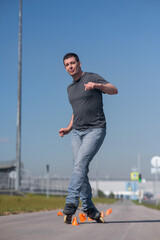 A Caucasian man rollerblades around the slalom course.