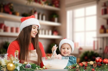 happy Mother and daughter preparing tasty Christmas food