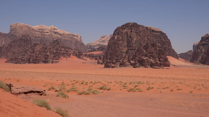 Fototapeta premium A trip to Wadi Rum desert in Jordan. Beautiful african travel photo. Sandy landscapes, mountains, rocks, dunes, and nature. Summer vacation in arab country. Moon Valley. Martian desert.