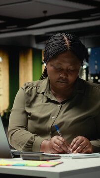 Vertical Video Corporate employee ripping and breaking textbook paper after writing something wrong, making a mistake due to workload and fatigue after hours. Writing a detailed report and making a