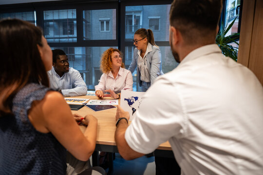 Team brainstorming session with diverse business colleagues in modern office setting - Powered by Adobe