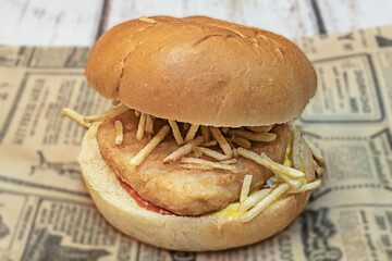 Crispy chicken burger with pepper jack cheese, sliced ​​jalapeños, sour cream, and fresh cilantro