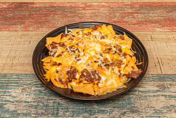 nachos with strips of roasted poblano pepper, crème fraîche, and slowly melted Manchego cheese