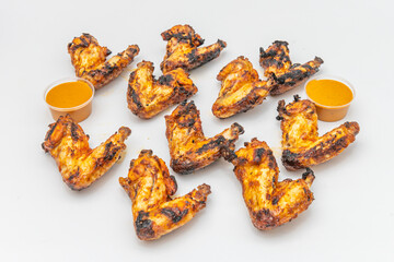 Balanced plate with six lemon and herb fried chicken wings, accompanied by creamy coleslaw and rosemary baked potato wedges