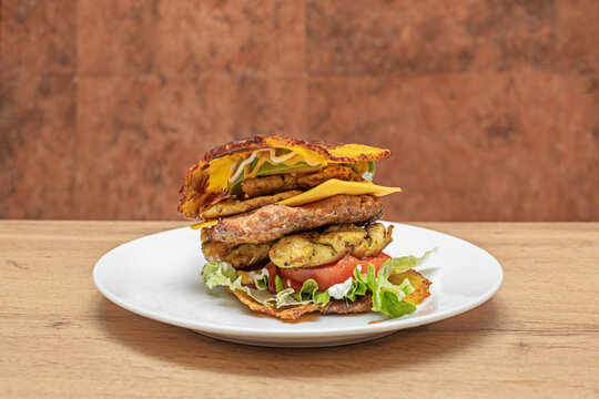 Crispy chicken burger with ripe avocado, heirloom tomato, red onion, and lemon aioli on toasted whole wheat bread
