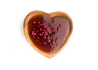 a bowl of raspberry jam on a white background