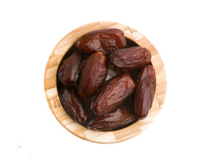 a bowl of dates on a white background