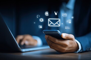 Digital Communication: Businessman using Smartphone and Laptop with Email Icon for Global Connectivity