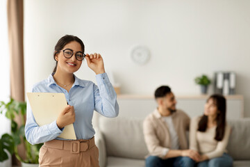 Portrait of a happy Arab female marital counselor after a productive session with a young married couple. The counselor smiles confidently while helping clients navigate their relationship issues.