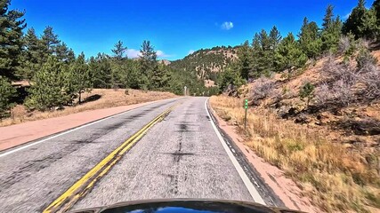 Drive along Colorado Highway 9 north in late fall early winter through rural high elevation area with snowy mountains in the distance - Powered by Adobe