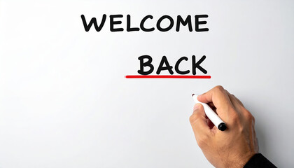 Welcoming hand writing welcome back on whiteboard to greet employees returning to office after period of labor market shortages. positive message for team