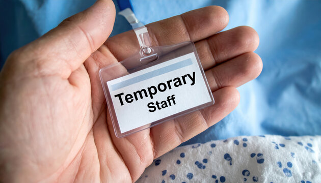 Hand holding temporary staff ID badge solution for labor market shortages. contract worker or freelancer filling vacant position in an uncertain economic climate