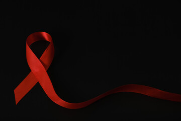 red ribbon symbol of World AIDS Day. Top view. Free copy space.