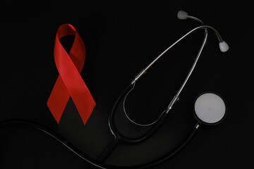 red ribbon symbol of World AIDS Day. Top view. Free copy space.