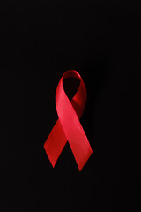 red ribbon symbol of World AIDS Day. Top view. Free copy space.