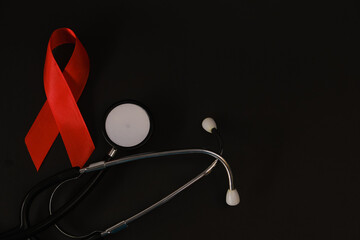 red ribbon symbol of World AIDS Day. Top view. Free copy space.